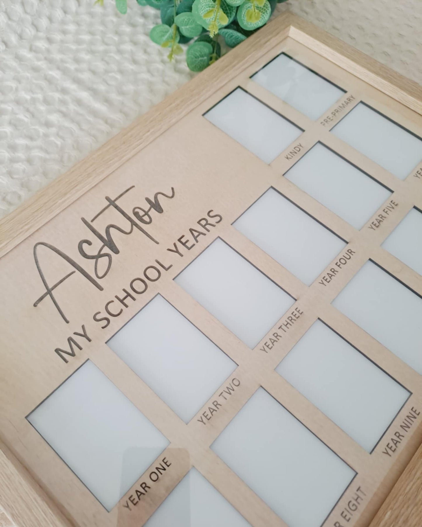 Wooden photo frame with 'My School Years' design on a textured surface.
