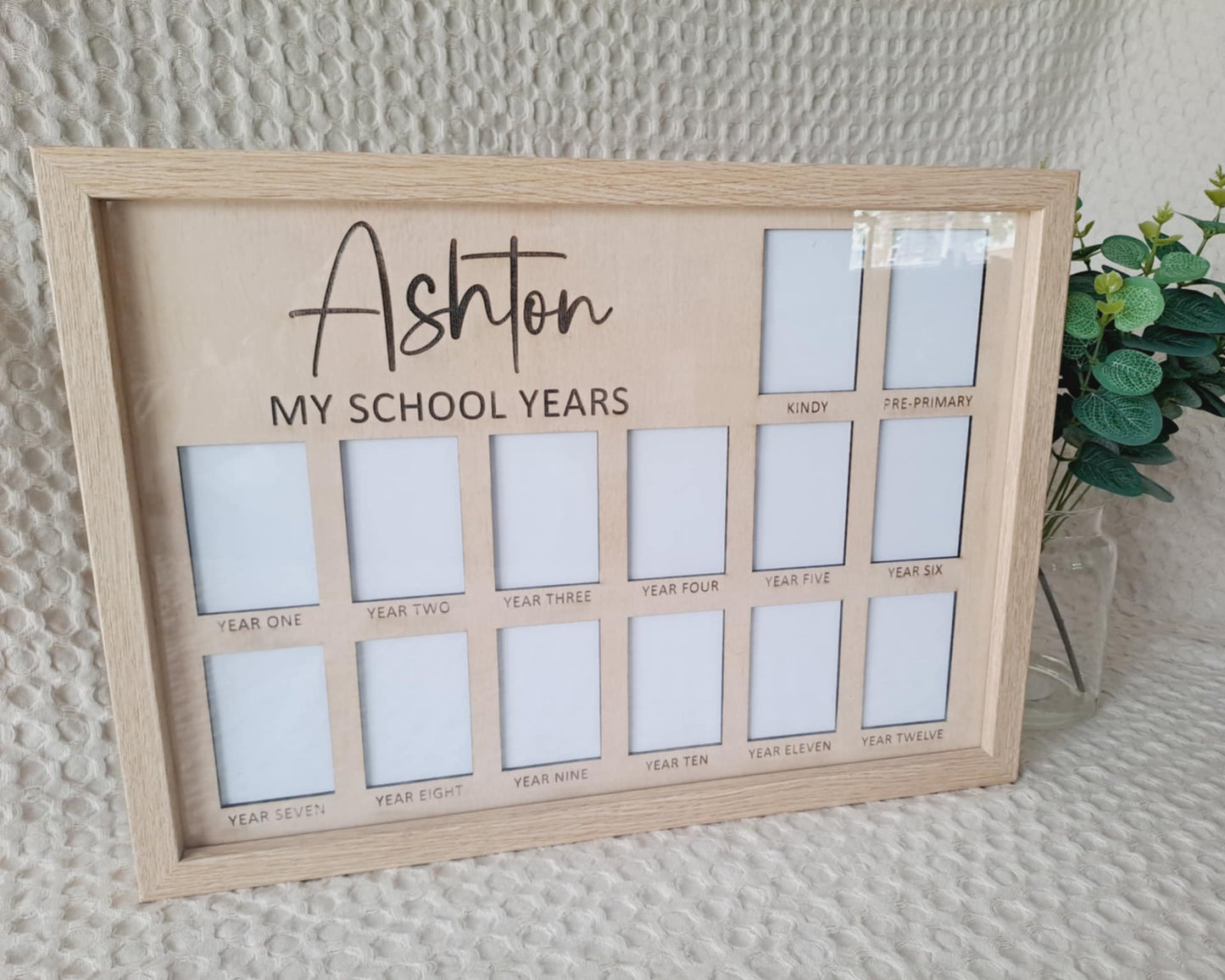 Wooden photo frame with multiple slots labeled for 'My School Years' on a textured wall background.