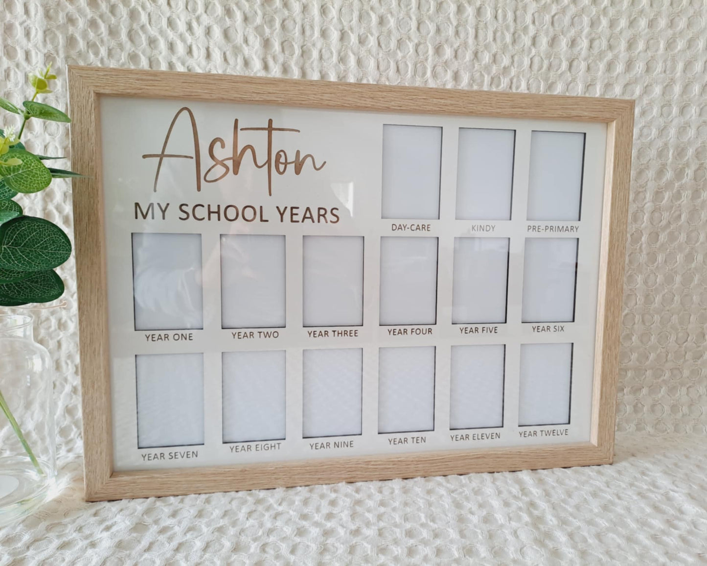 Framed display with cut-out sections labeled for 'My School Years' on a textured surface.