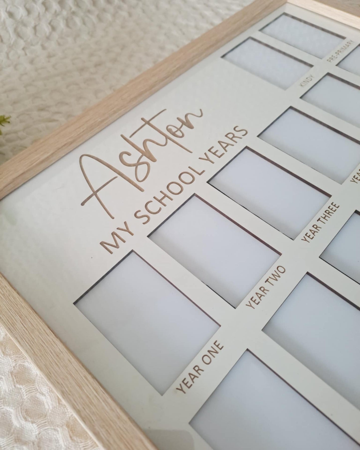 Personalized photo frame with My School Years' text on a textured surface.