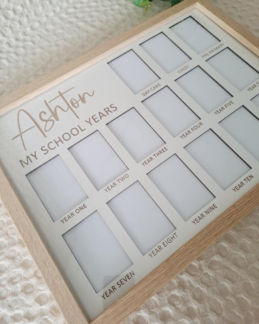 Wooden photo frame with cut-out sections labeled 'My School Years' on a textured surface.