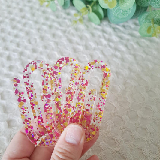 Close-up of large glittery paperclip bookmark with shimmering acrylic detail.